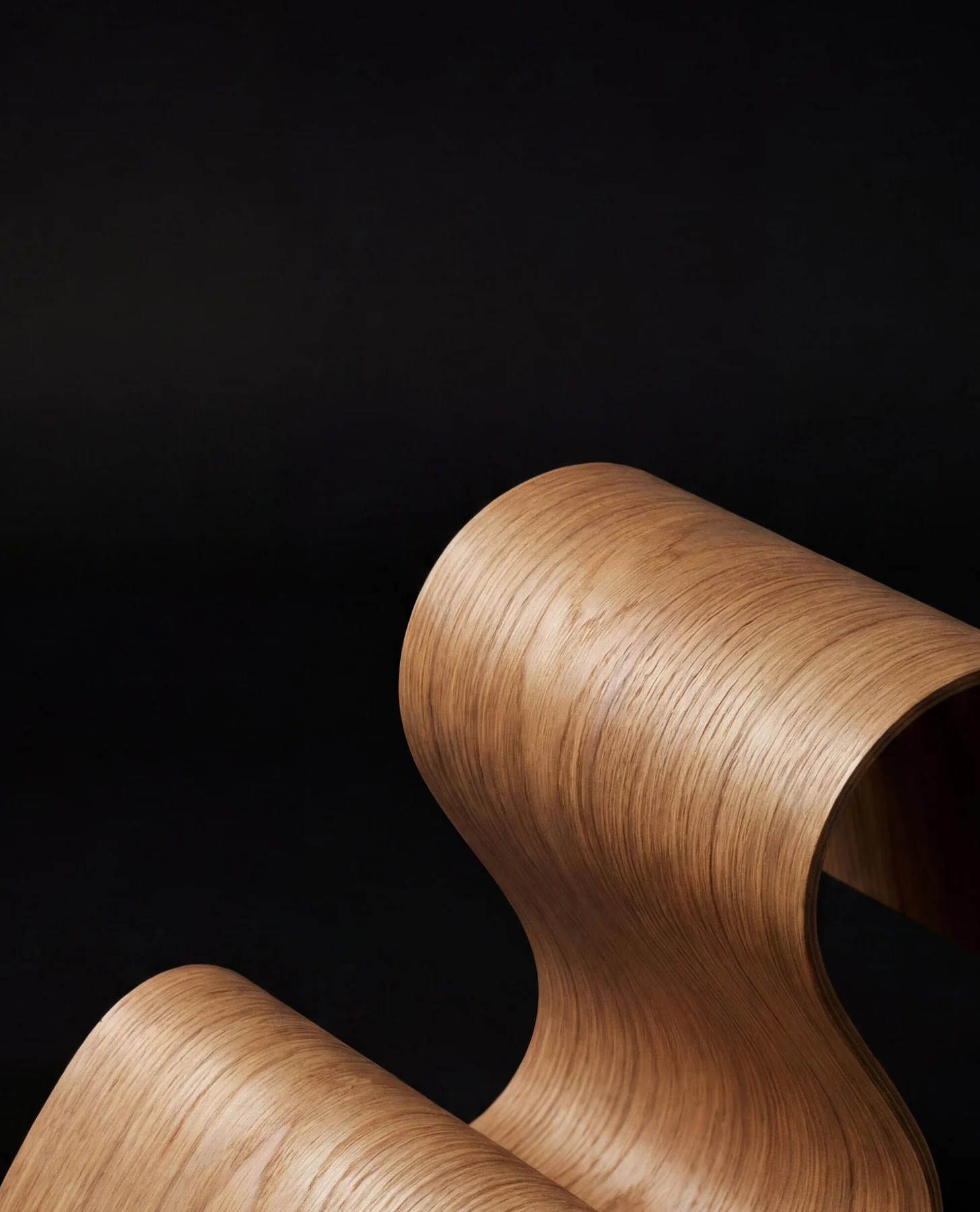 Curved premium wood veneer on a dark background